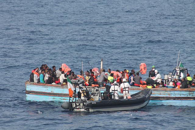 Une embarcation avec des personnes migrantes est secourue par un bateau à moteur