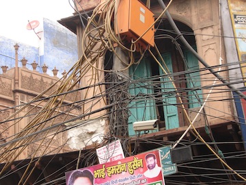 An Electric Pole with Hundreds of Connections in a Crowded Street in Old Delhi